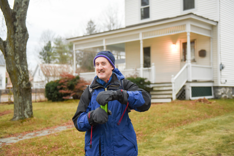 chris in front of his house