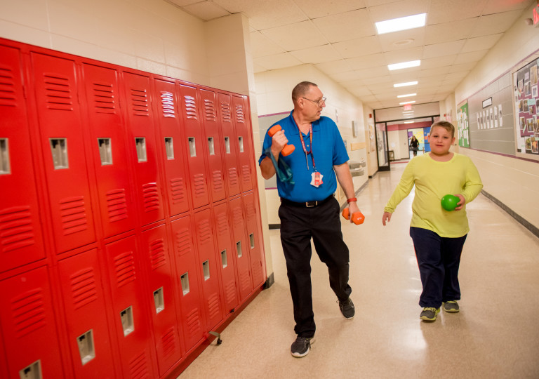 Joe waling with student