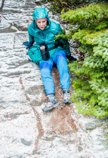 Susan sliding down rock