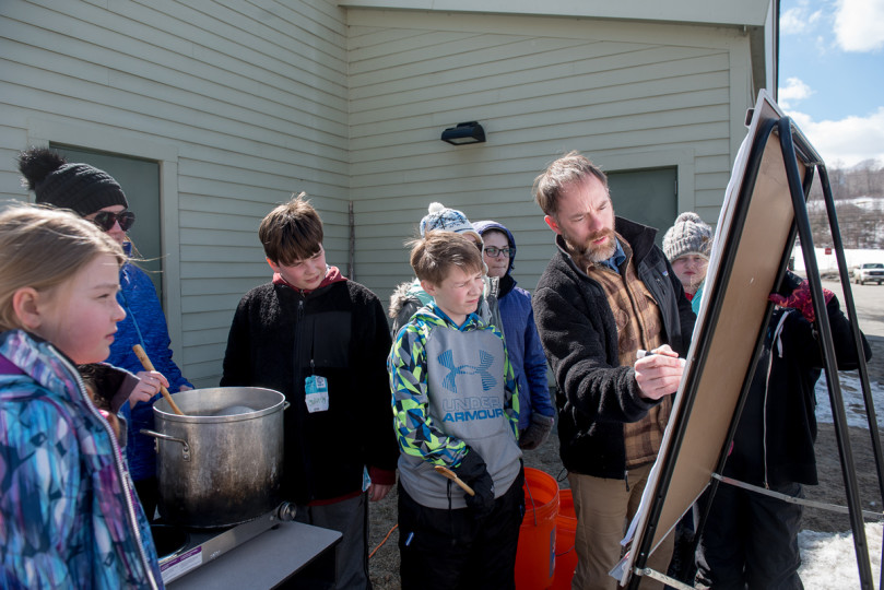 Andrew teaching with chart outside